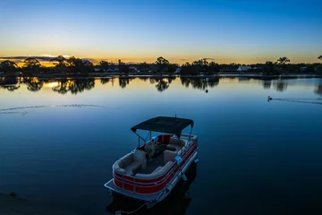 Fotobehang Ohmas Bay Sunset with Red Pontoon Boat © Merrillie
