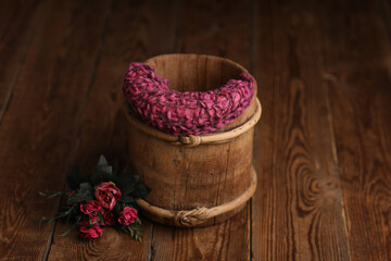 
Newborn Backdrops Photo for Girls. Vintage bucket with flowers on a wooden background.