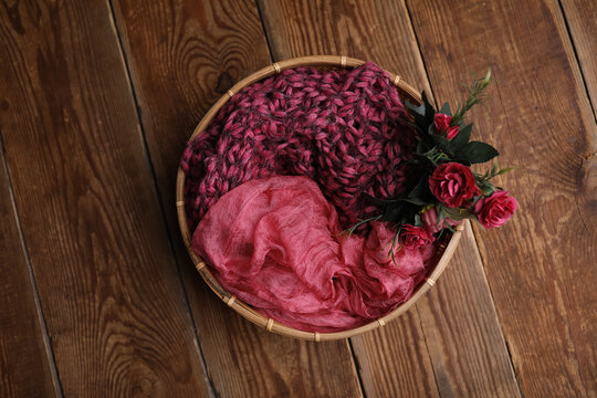 Backgrounds for newborns Photo. Basket with flowers on a vintage wooden background.
