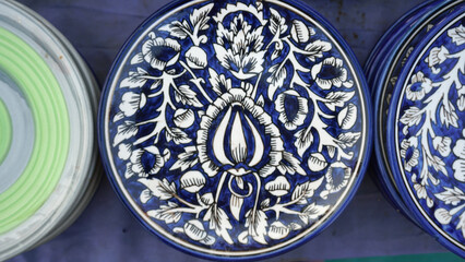 Collection of colorful pots and vases and also plates and bowls  in market for selling