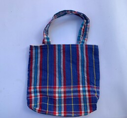 Blue striped cloth bag the popular instead of plastic bags to help reduce global warming and be environmentally friendly.