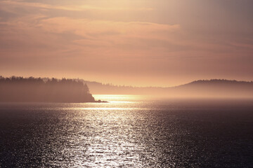Sunset illuminating the mist between islands