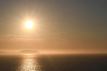 Sunset over an island shrouded with mist