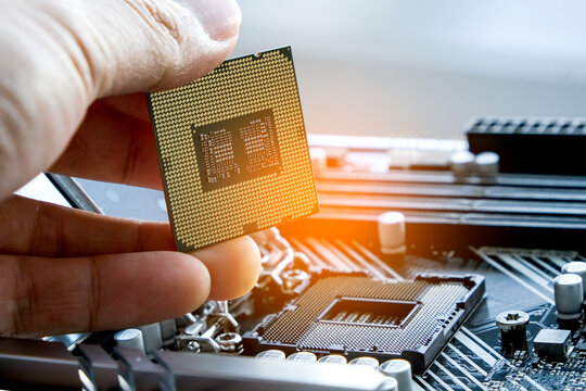 Hand of computer engineering brings computer cpu processor memory change components into socket processor for maintenance.Technology and development concept