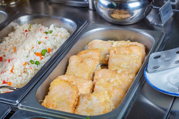 Hot pieces of fish fried in breadcrumbs.