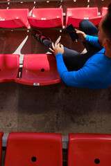 Sportsman using phone at the stadium