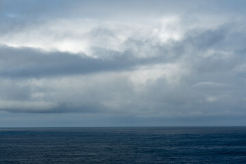 Naklejka na ściany i meble Thick clouds over the ocean