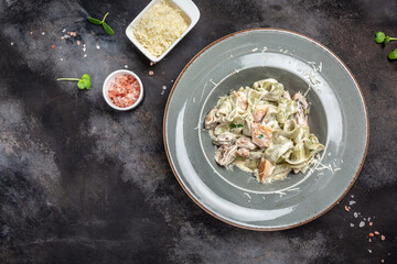 Pasta fettuccine with mushrooms and fried chicken ham in creamy cheese sauce. Tagliatelle pasta. Traditional Italian cuisine. banner, menu, recipe place for text, top view