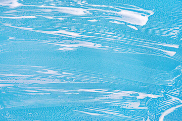 Cleaning background texture - chemical soap detergent foam on a clear glass