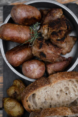 Barbecue. Traditional asado criollo plate. Top view of chorizos, pork sausages, grilled sweetbreads, potatoes and bread.