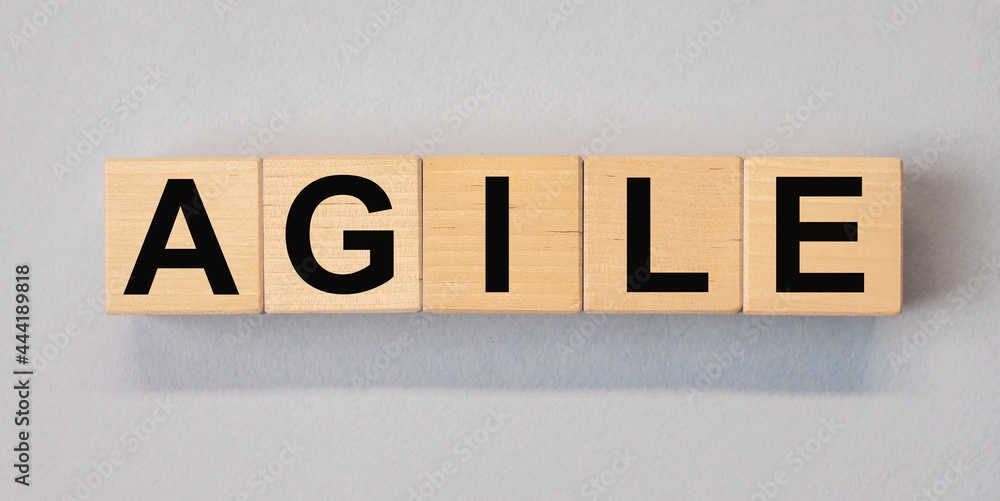 Poster agile word on wooden cube blocks on background.
