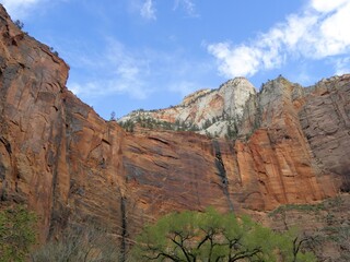 Awe-inspiring steep and colorful red and white canyon walls  on a sunny day in zion national park,...