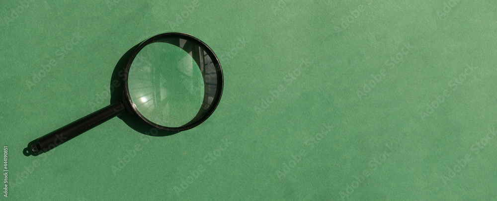 Poster magnifying lens over green background with copyspace. eco banner with magnifier and place for text.