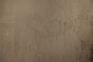 Smooth soil colored concrete texture. Background of cement wall with cracks and repair marks