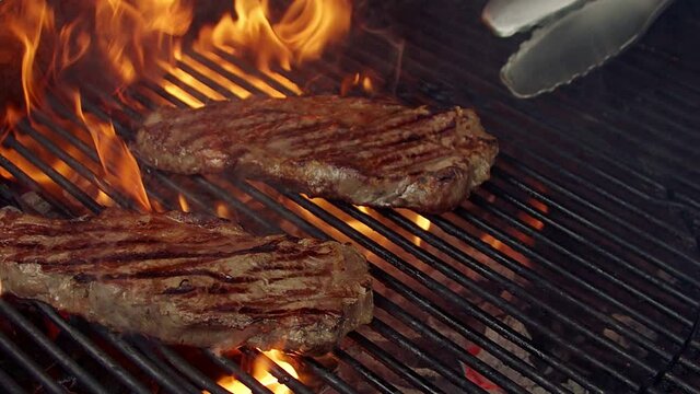 BBQ steak on grill. Grilling on fire meat
