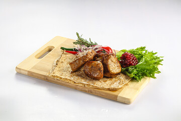 Pork tenderlion kebab over board