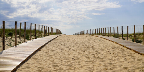 wooden path coast access with sand beach waves entrance to ocean atlantic sea in cap-ferret france