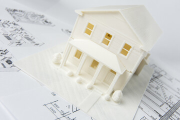 Model of the family house printed on a 3D printer with white filament by FDM technology for...
