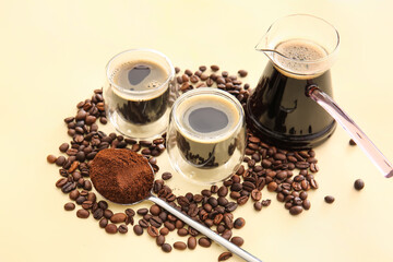 Cezve, cups of turkish coffee and beans on color background