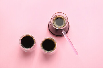 Cezve and cups of turkish coffee on color background