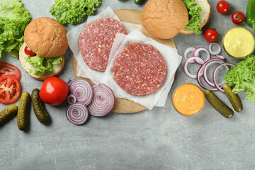 Concept of cooking burger on gray textured table