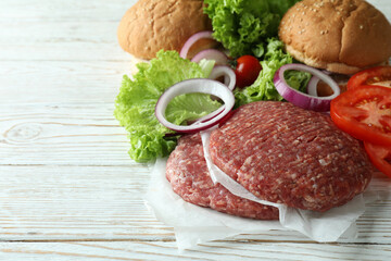 Concept of cooking burger on white wooden table