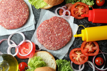 Concept of cooking burger on black smokey table