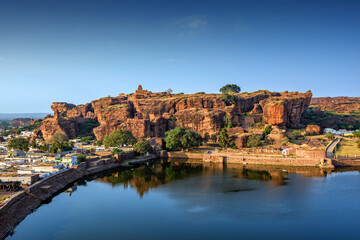 Fototapeta na wymiar Agasthya Lake and surrounding red rock hills. Badami, Karnataka, India.