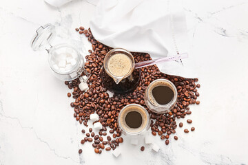 Obraz na płótnie Canvas Cezve, cups of turkish coffee and beans on light background
