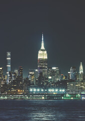 Fototapeta na wymiar Manhattan skyline at night, color toning applied, New York City, USA.