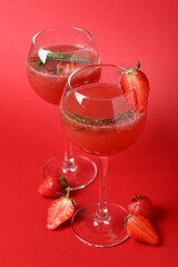 Alcoholic cocktail Rossini and ingredients on red background