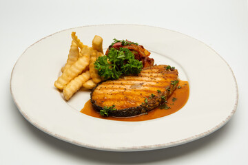 Grilled salmon with lemon and potato on background.