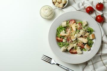 Concept of tasty eating with Caesar salad on white table
