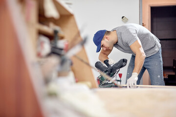 Young adult man working on a DIY budget renovation of his new home apartment.