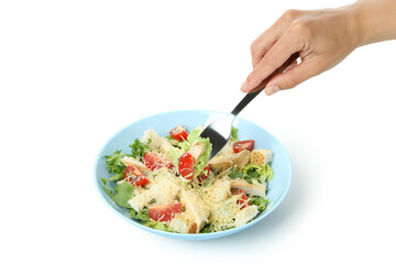 Female hand with fork and Caesar salad isolated on white background