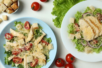 Concept of tasty eating with Caesar salad on white background