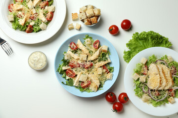 Concept of tasty eating with Caesar salad on white background