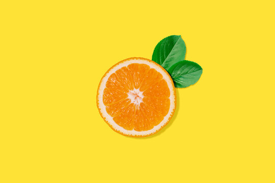 Creative concept food health diet photo of cut raw orange fruit on orange background.