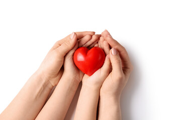Hands of woman and child with red heart on white background