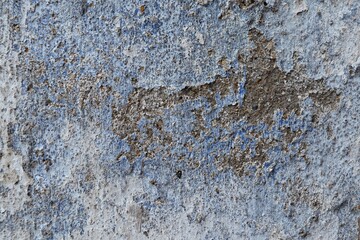 Blue and grey old stone wall with peeling paint background	