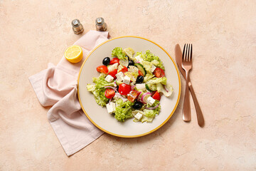 Plate with tasty Greek salad on color background