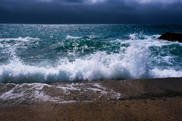 Amazing sea wave on the black sand coastline. 