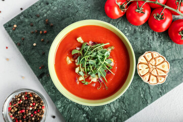 Bowl with tasty gazpacho on light background