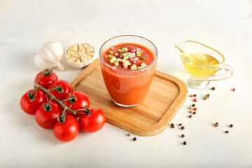 Composition with tasty gazpacho in glass on light background