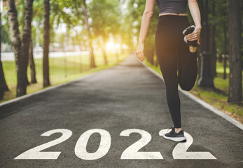 Naklejka na ściany i meble female feet in sneakers at the start. Beginning and start of the new year 2022, goals and plans for the next year