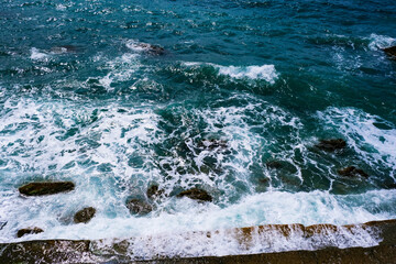 Amazing sea wave on the black sand coastline. 