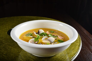 asian premium banquet menu double boiled seafood with shell yellow stock pumpkin thick soup on gold background dining table