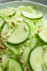 Tasty cabbage salad with sunflower seeds on plate, closeup
