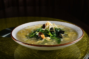 asian premium banquet menu stir fried water spinach vegetables with 3 type of golden eggs in thick gravy sauce on gold background dining table