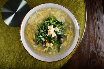asian premium banquet menu stir fried water spinach vegetables with 3 type of golden eggs in thick gravy sauce on gold background dining table